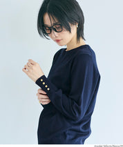 Simple long-sleeved knitted top with gold cuffs