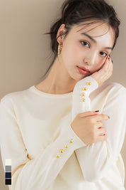 Simple long-sleeved knitted top with gold cuffs