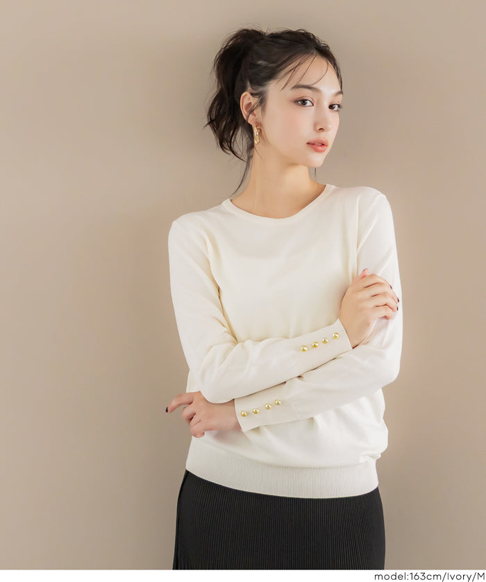 Simple long-sleeved knitted top with gold cuffs