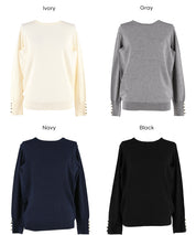 Simple long-sleeved knitted top with gold cuffs