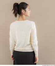Simple long-sleeved knitted top with gold cuffs