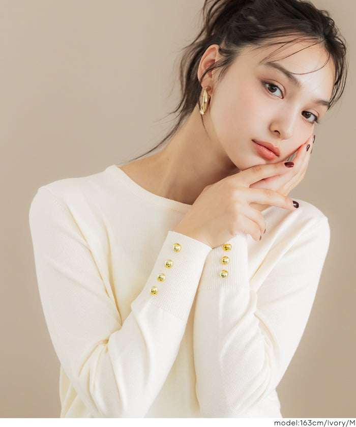 Simple long-sleeved knitted top with gold cuffs