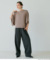 Loose-fitting top with draped sleeves