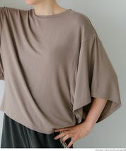 Loose-fitting top with draped sleeves